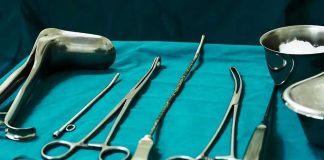 Surgical instruments arranged on a teal drape