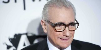 Martin Scorsese wearing glasses and a dark suit at an event