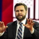 Vance’s SAVAGE Joke About Texas Democrat Man in suit speaking on stage with hands raised