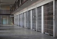 prison cell block with metal barred doors