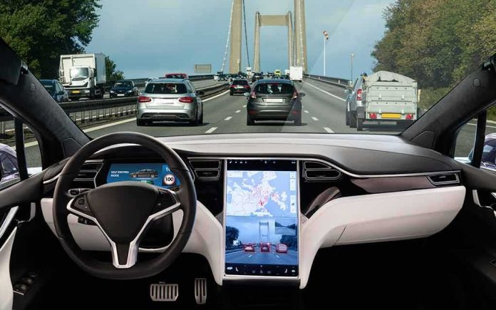 shutterstock_1174395055 Self-driving car interior on a busy bridge highway