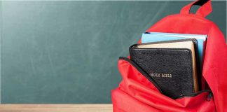 $47K Christian School Accused of Ignoring RACIST Bullying Red backpack with books on a classroom desk