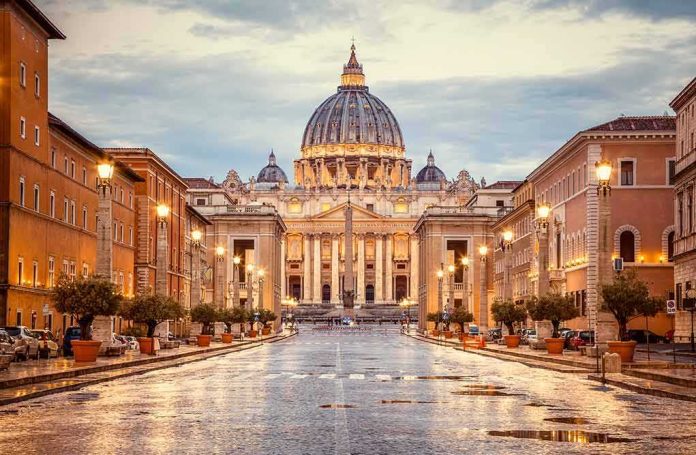 shutterstock_1218983827 St. Peter's Basilica at the end of a wet street at dusk