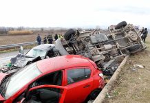 Overturned truck and damaged cars after highway crash