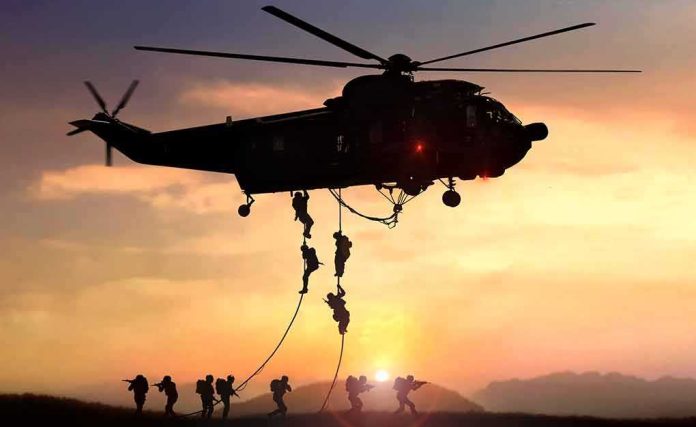 military helicopter with soldiers fast-roping at sunset