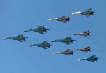 A formation of military jet fighters flying in a clear blue sky