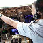 Passengers Fight for Their Lives Midair Pilot adjusting controls in an airplane cockpit