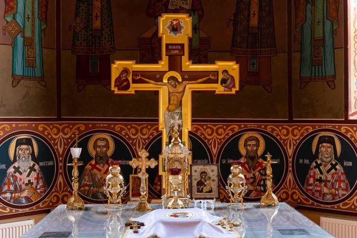 shutterstock_2216179489 Orthodox church altar with large gilded cross and icons