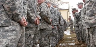 Livestream of Firing Squad Execution Canceled by Trump Soldiers in camouflage uniforms stand in two facing rows outdoors