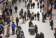 Crowd of travelers in an airport arrivals hall