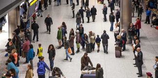 Airports Will SCAN Faces Instead of Passports Crowd of travelers in an airport arrivals hall