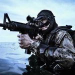 19 Gunmen Closed In on Navy SEALS Combat diver aiming rifle in open water