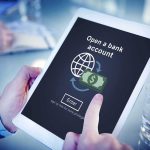 Person using tablet with online bank account signup screen