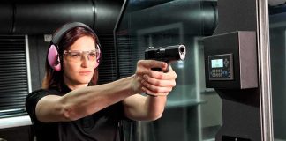 Female Gun Ownership SURGES Across America Woman aiming a handgun at an indoor shooting range