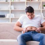 New Injection DESTROYS Dangerous Belly Fat Manny MUA sitting on a couch pinching his belly
