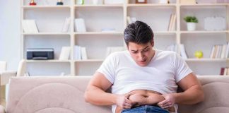 New Injection DESTROYS Dangerous Belly Fat Manny MUA sitting on a couch pinching his belly