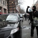 Rioters DESTROY 143-Year-Old Town Hall Masked protester raises tool to strike black car on city street