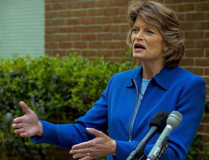 shutterstock_731705743 Lisa Murkowski speaking at an outdoor press conference with microphones in front
